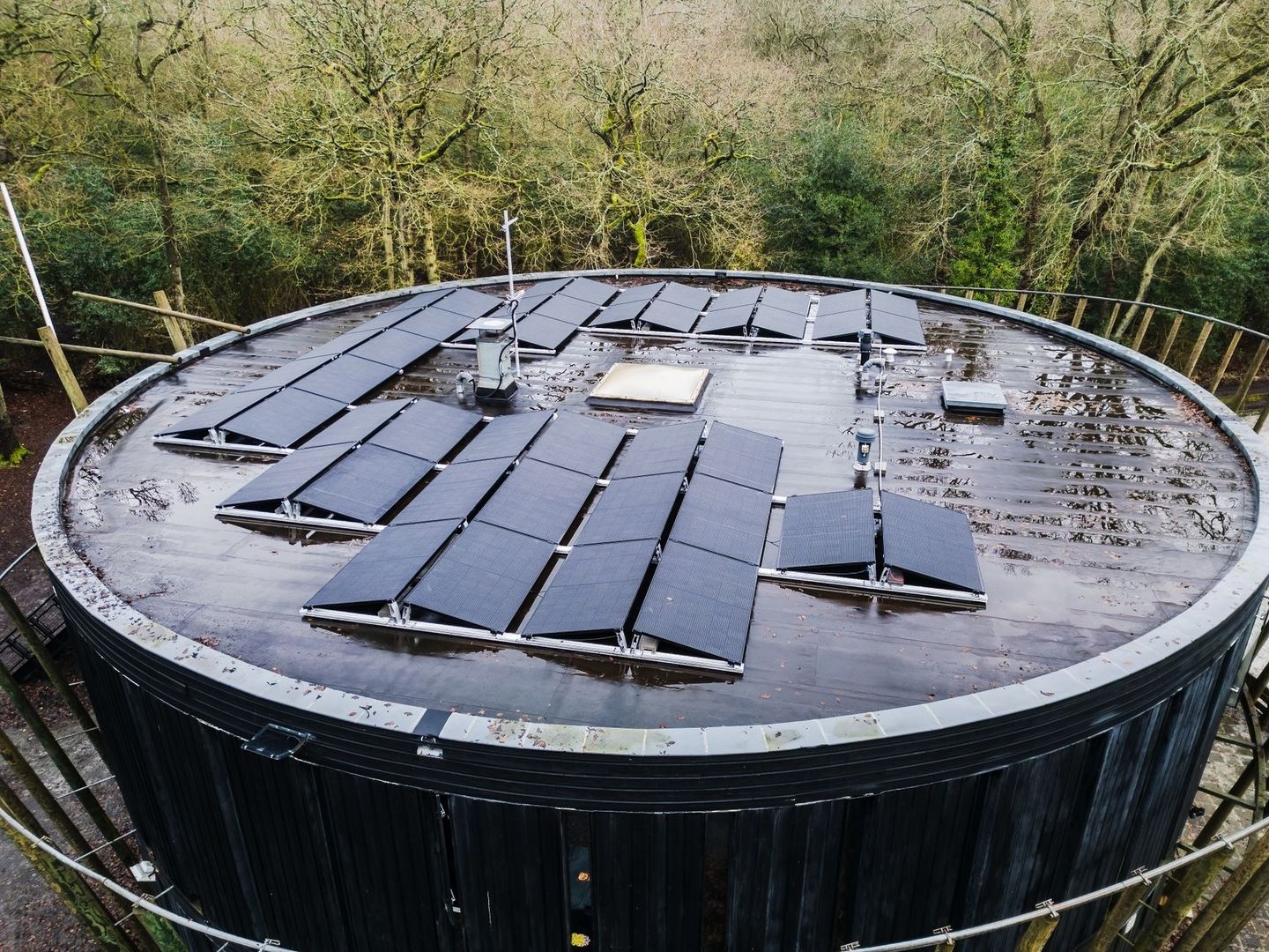 Solar panels installed across the roof of a large circular structure