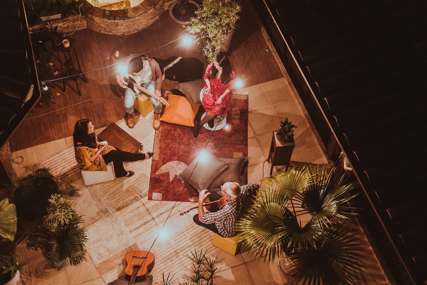 Small outdoor music gathering with live musicians and seated guests